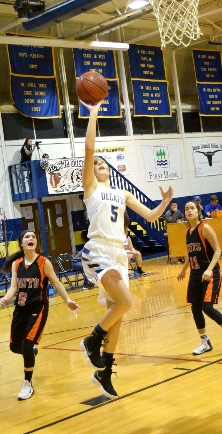 Westside Eagle Observer/MIKE ECKELS Paige Vann (Decatur 5) puts up a layup from just inside the lane during the third quarter of the Decatur-Watts senior girls' basketball contest at Peterson Gym in Decatur on Dec. 19. Vann was the leading scorer for the Lady Bulldogs with 15. She shot 100 percent from the free-throw line for one of her best games of the season.