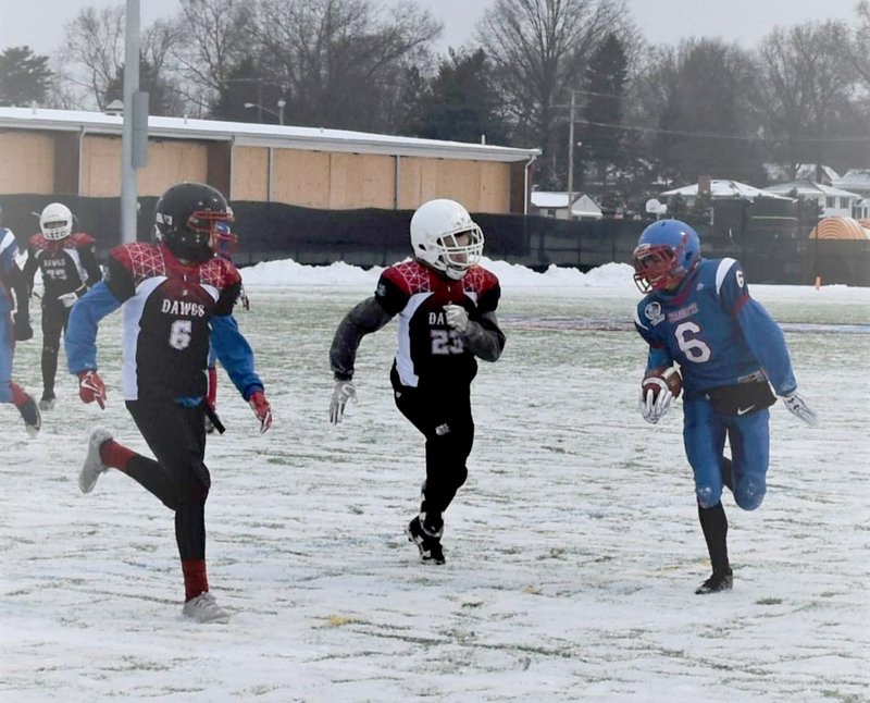 Photo submitted Jed Derwin, No. 23, looks to make a tackle during a youth football game played earlier this month during the National Youth Championships held in Canton, Ohio. Derwin is from Siloam Springs and played for the Arkansas Dawgs, a team based in Northwest Arkansas.