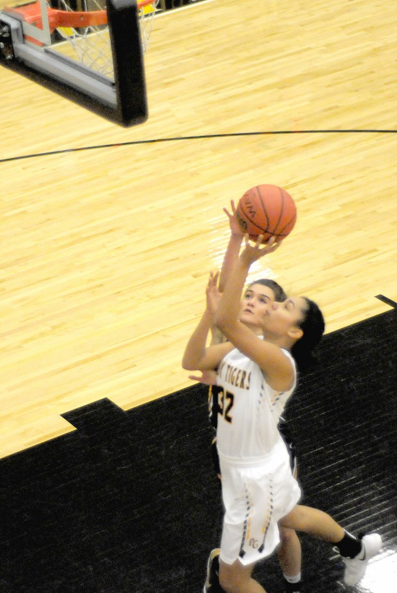 MARK HUMPHREY ENTERPRISE-LEADER Prairie Grove freshman Jasmine Wynos shoots a layup to finish a fast-break with a Haas Hall defender bearing down. Wynos scored 7 points as the Lady Tigers defeated Haas Hall, 51-13, on Dec. 6.