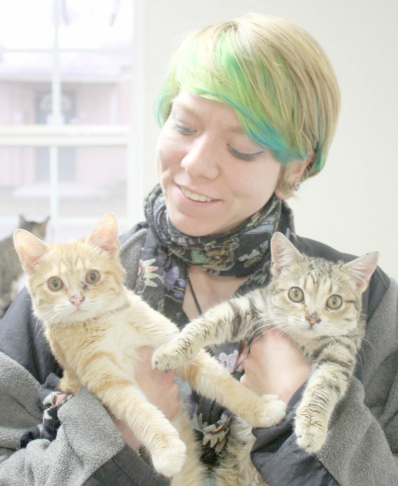 Keith Bryant/The Weekly Vista Bella Vista Animal Shelter employee Elizabeth May holds 5-month-old shelter kittens Olivia (left) and Tessa. The sisters are currently being treated for a rare enlarged colon.