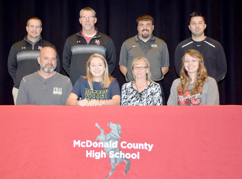 RICK PECK SPECIAL TO MCDONALD COUNTY PRESS McDonald County's Kenzie Stephens recently signed a letter of intent to play softball next year at Cottery College in Nevada, Mo. Pictured, front from left, are: Richard Stephens (dad), Kenzie Stephens, Jennifer Stephens (mom) and Makayla Stephens (sister); back, Heath Alumbaugh (MCHS coach), Lee Smith (MCHS coach) Mark Skapin (Cottey coach) and Skyler Rawlins (MCHS head coach).