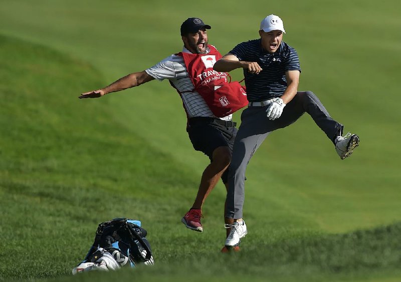 Jordan Spieth (right) and caddie Michael Greller celebrate winning this year’s Travelers Championship. The pair also were in the middle of one of the memorable shots of the 2017 British Open, also won by Spieth, when he told Greller to get the ball out of the hole after making a lengthy eagle putt. 