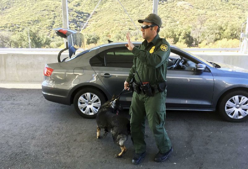 A border patrol agent stops a vehicle earlier this month at a checkpoint in Pine Valley, Calif. The clash between state and federal marijuana laws will play out in California when recreational marijuana becomes legal in the state on Monday. 