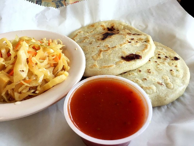 Two papusas — one filled with cheese, the other with a cheese-and-chicken mixture — are listed among the starters on the menu at El Pollo Rico, but with a bowl of spicy slaw, they’re filling enough to be a full meal. 