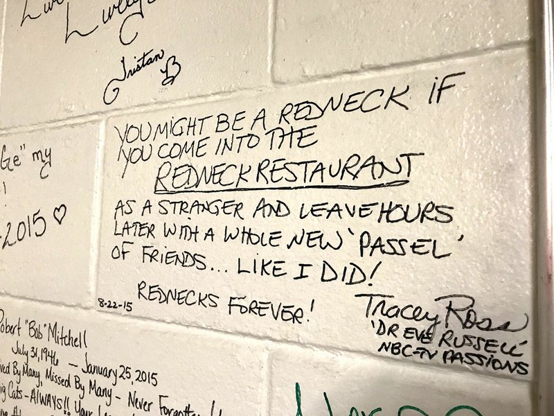 Photo by Sally Carroll/McDonald County Press Tracey Ross, aka Dr. Eve Russell from the soap opera, "Passions," christened the wall at the Redneck Catfish &amp; BBQ restaurant in Goodman with her signature. Ross was the first person to sign the wall, reviving an old tradition at the caf&#233;.