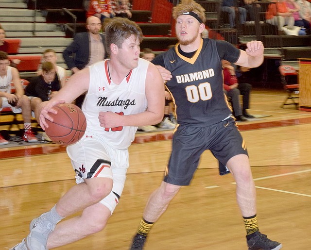RICK PECK SPECIAL TO MCDONALD COUNTY PRESS McDonald County's Cooper Reece drives around Diamond's Hunter Renfor during the Mustangs 69-41 win on Dec. 21 at MCHS.