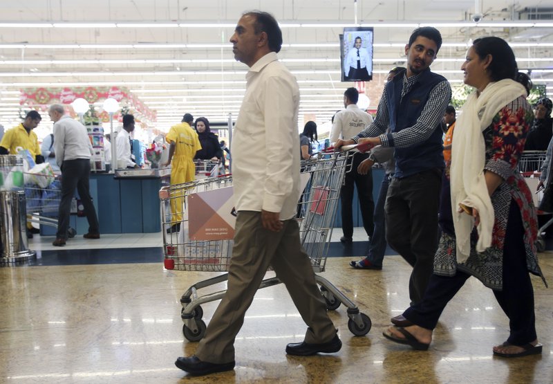 In this Wednesday, Dec. 20, 2017 photo, people leave a hypermarket at a shopping mall in Dubai, United Arab Emirates. Residents in the traditionally tax-free haven of Dubai are preparing for higher prices when the government imposes a 5 percent value-added tax on most goods like food, gasoline and water and electricity bills starting Jan. 1, 2018. Governments in oil-exporting Arab Gulf states are looking for new ways to boost revenue amid continued lower oil prices. (AP Photo/Kamran Jebreili)