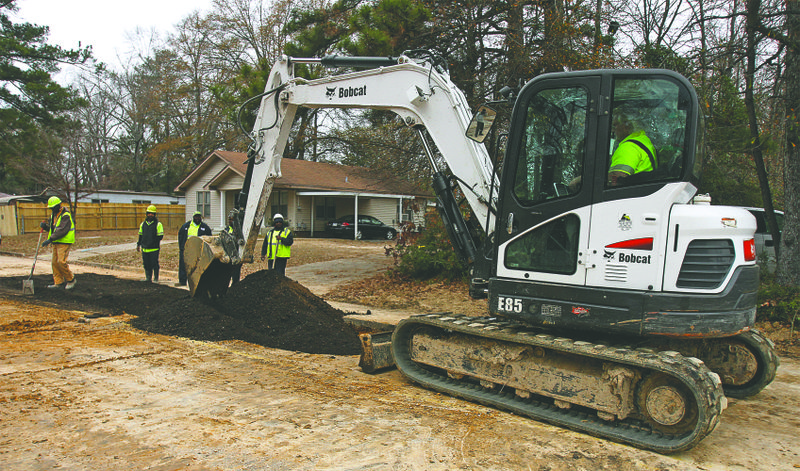 Repair work: Workers from the El Dorado Water and Sewer Dept. put the finishing touches on road repair along a stretch of W. Eighth Street. Water pipes beneath the street were repaired after breaking which caused the surrounding sediment to cave inward.