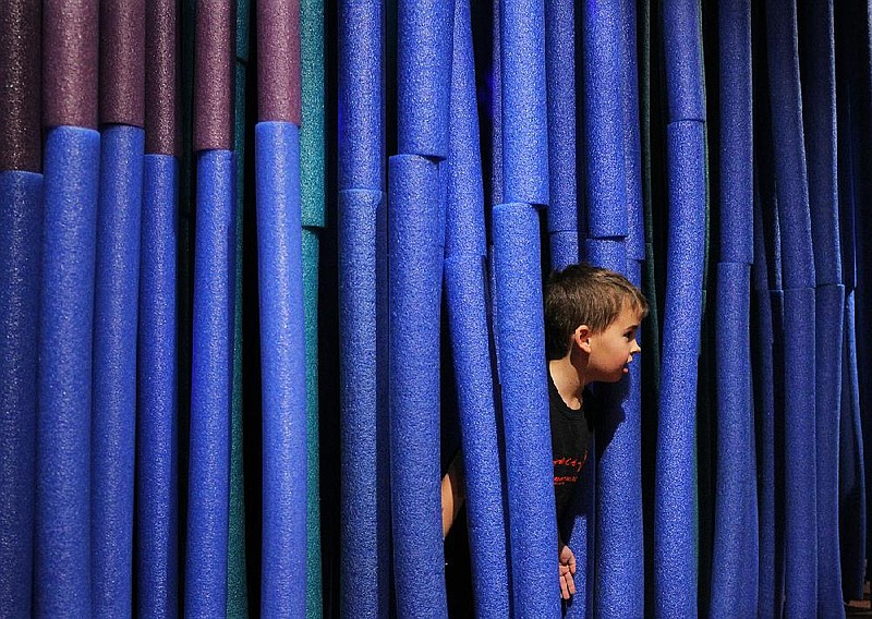 Charlie Hedlund of Lowell breaks through a maze of dangling pool noodles at the Museum of Discovery in Little Rock in this Thursday, Dec. 28, 2017, file photo.