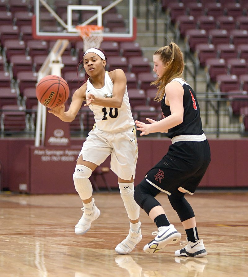 The Sentinel-Record/Mara Kuhn TAKE THAT: Hot Springs' Ariana Guinn (10) makes a pass as Pea Ridge's Kiley West (3) defends during the Kameron Hale Invitational basketball game at Lake Hamilton Wolf Arena on Thursday. The Lady Trojans are matched up with Centerpoint in the winner's bracket at 4 p.m. today.