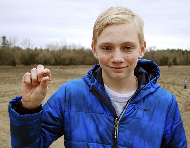 This March 11, 2017, file photo, provided by the Arkansas Department of Parks & Tourism shows Kalel Langford holding a 7.44 carat diamond he found at Crater of Diamonds State Park in Murfreesboro, Ark. The story was one of Arkansas' oddest news stories of 2017. 