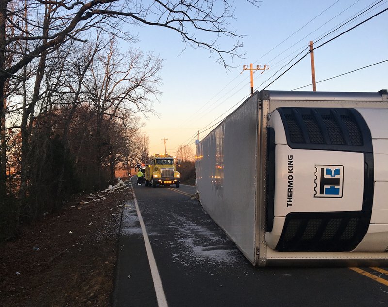 An overturned tractor-trailer spills part of its milk haul Friday, Dec. 29, 2017, on Cleland and Tadpole roads in Cabot, according to the Pulaski County sheriff's office. 