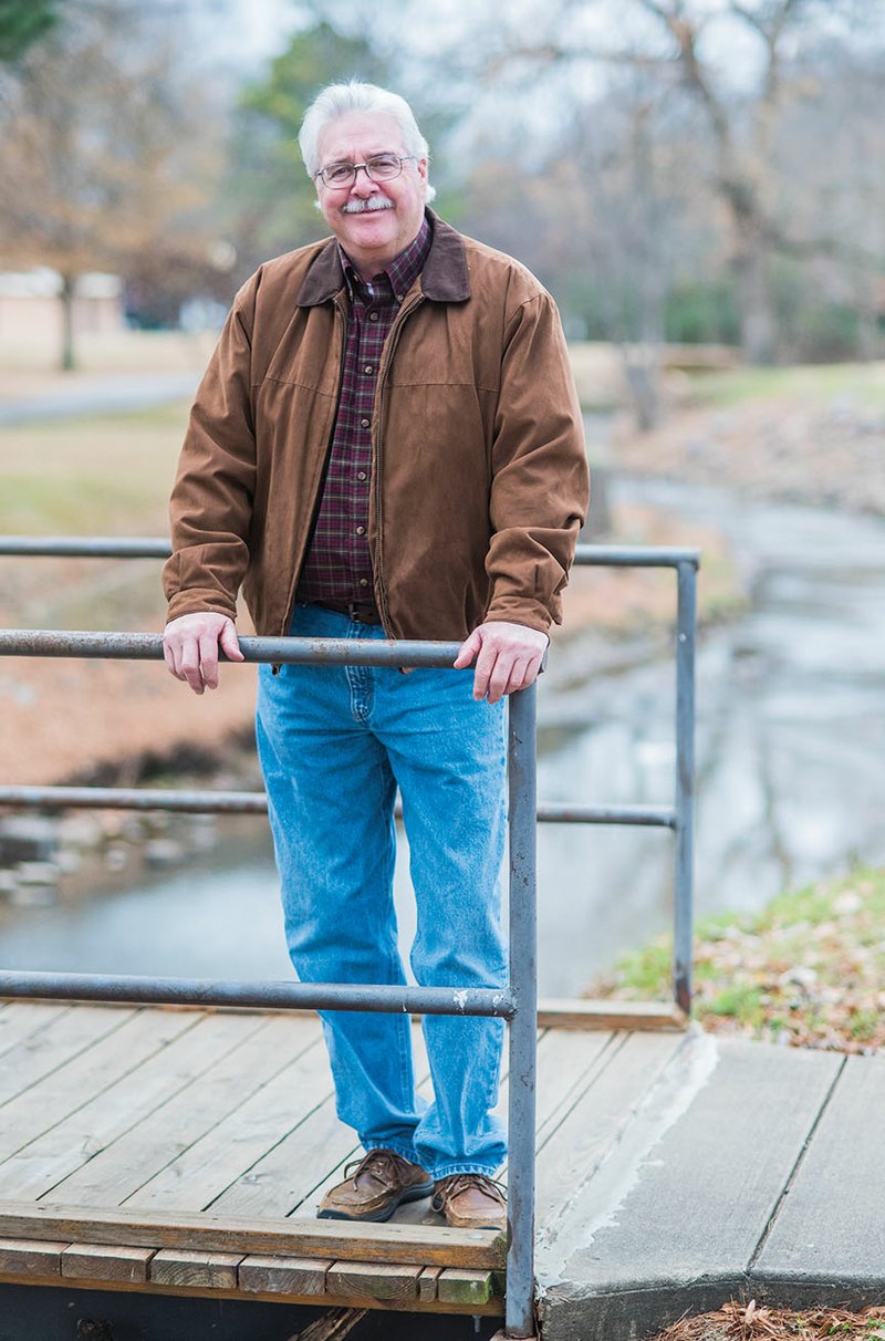 Mack Hollis, director of Russellville Recreation and Parks, stands on a bridge near City Park. He will retire Jan. 26 after 35 years as director and 38 years in the department. During his tenure, Hollis has seen the number of parks grow from eight to 23 and the construction of the Russellville Aquatic Center.