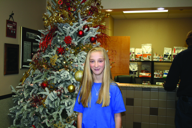 Smile: Emmalou Parker, Arkansas Children’s Foundation ambassador, smiles in the reception area of Goodwin Animal Hospital. Emmalou was diagnosed with Pierre Robin sequence, a birth defect that affects the development of the jaw, tongue, airway and roof of the mouth. Brittany Williams/News-Times