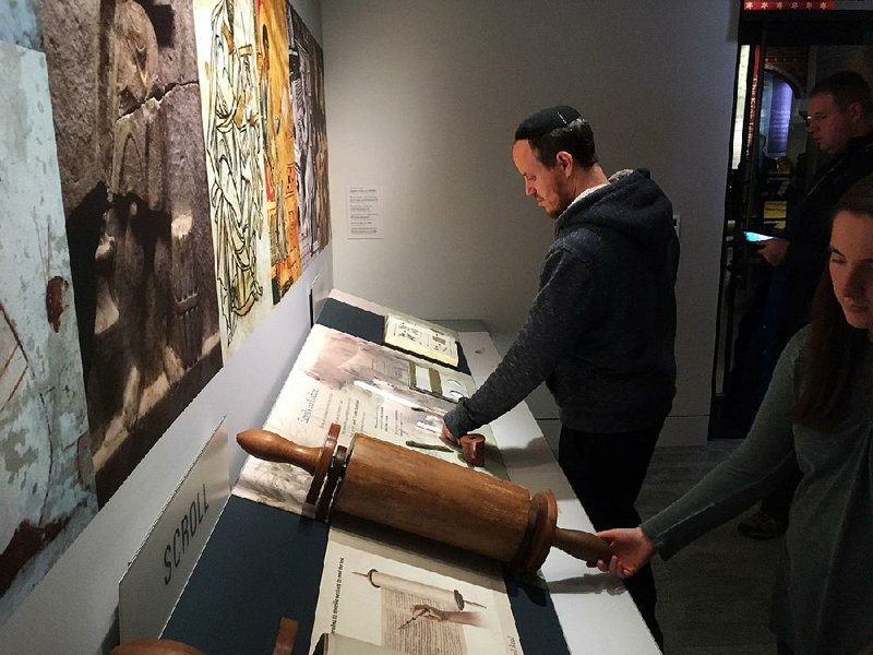 Rabbi Shmuel Herzfeld, of the modern Orthodox synagogue Ohev Shalom in Washington, examines a Torah exhibit at the Museum of the Bible.
