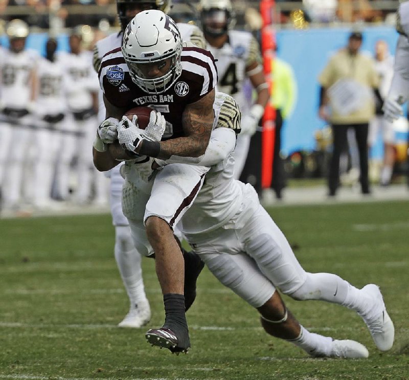 Texas A&M’s Trayveon Williams (5) rushed seven times for 65 yards and scored a 2-yard touchdown in the Aggies’ 55-52 loss Friday to Wake Forest in the Belk Bowl. Williams also had one reception for 12 yards.