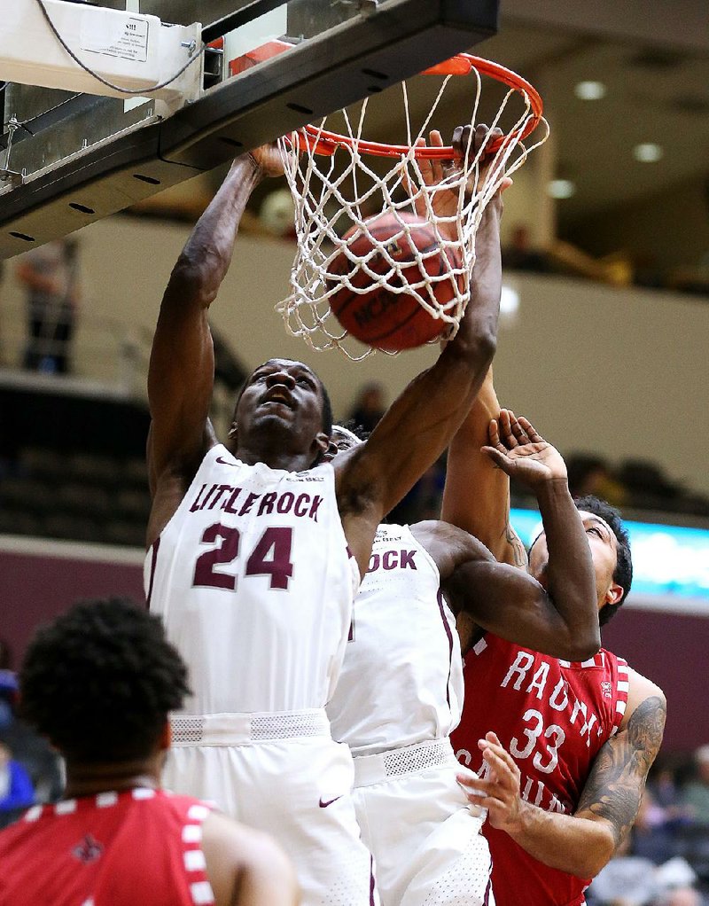 UALR’s Ben Marcus (24) dunks in two of his eight points in the Trojans’ 77-63 loss to Louisiana-Lafayette on Friday night at the Jack Stephens Center in Little Rock.