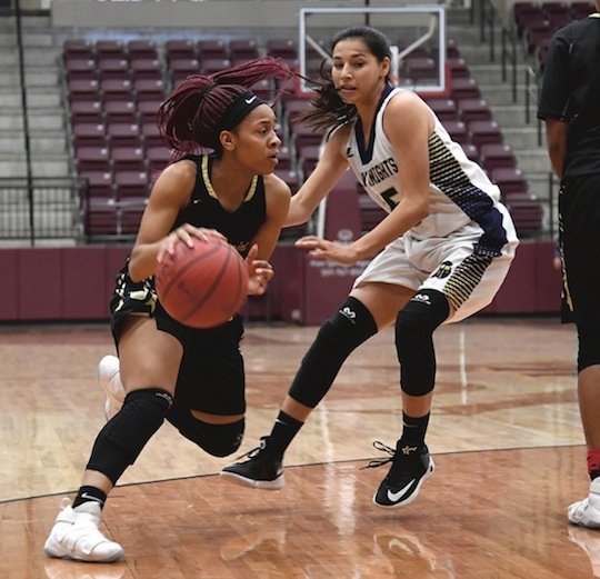 The Sentinel-Record/Mara Kuhn MAN TO MAN: Hot Springs guard Ariana Guinn, left, looks for a lane as she is defended by Centerpoint's Jasmine Keener, right, during the Lady Trojans' 42-27 win Friday in the Kameron Hale Invitational. The Lady Trojans are in today's girls' final at 6:30 in Lake Hamilton Wolf Arena, where they will face the host Lady Wolves.