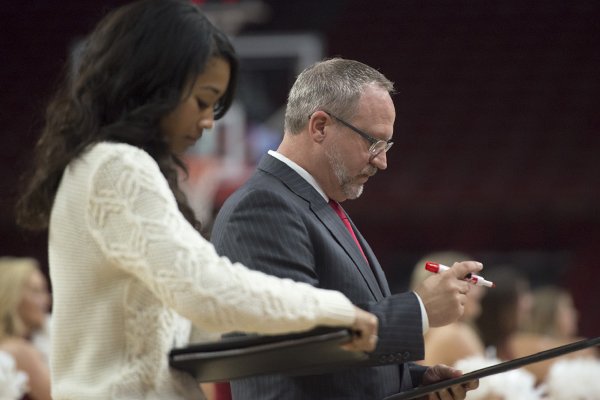 Arkansas coach Mike Neighbors, right, and assistant coach Lacey Goldwire look at notes during a game against Grambling State on Thursday, Dec. 28, 2017, in Fayetteville. 