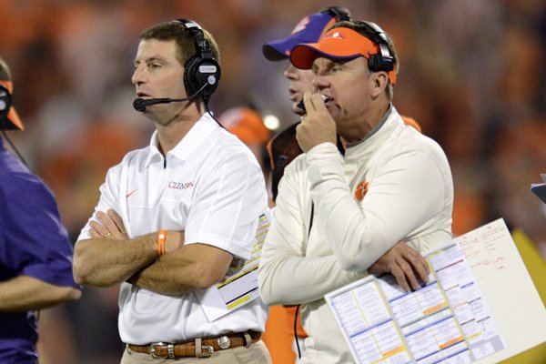 Clemson head coach Dabo Swinney, center, along with defensive coordinator Chad Morris, right, watch the action during the second half of an NCAA college football game against Maryland Saturday, Nov. 10, 2012 at Memorial Stadium in Clemson, S.C. Clemson won 45-10. (AP Photo/Richard Shiro)

