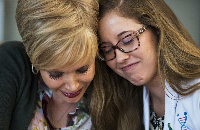 Marilyn Marshall-Miller (left), who underwent genetic testing after being diagnosed with cancer in 2016, has a tearful moment Friday with genetic counselor Courtney Cook while recalling Marshall-Miller’s experience. 