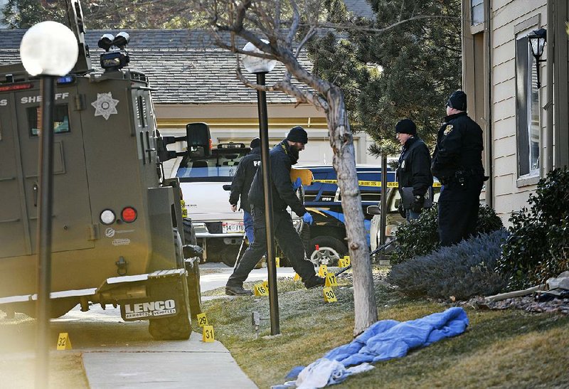 Authorities investigate the shooting of several sheriff’s deputies in an apartment complex Sunday in Denver. 