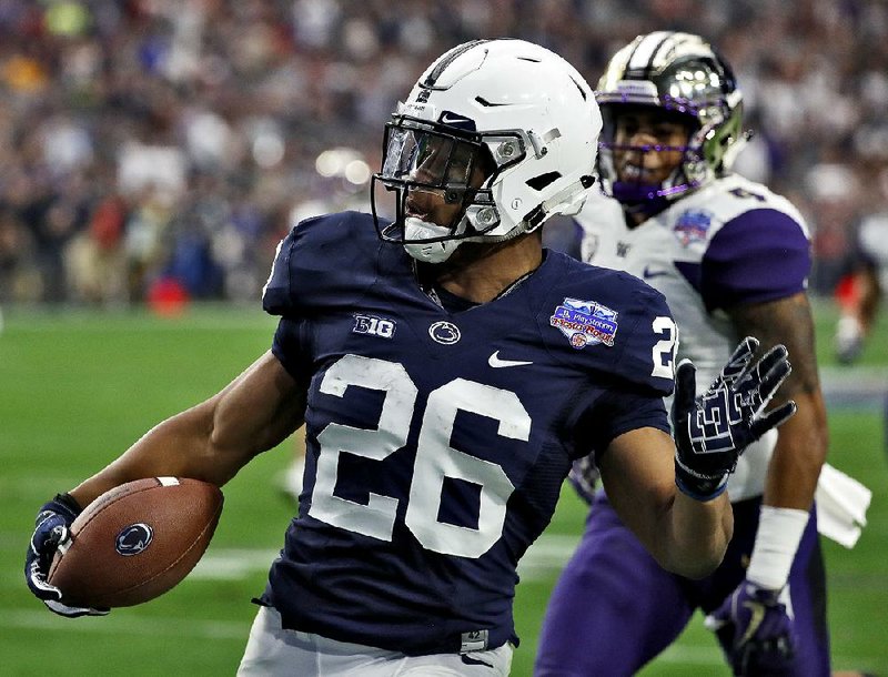Penn State running back Saquon Barkley breaks free for a 92-yard touchdown run in the Nittany Lions’ 35-28 victory over Washington in Saturday’s Fiesta Bowl. Barkley announced Sunday he is going to enter the NFL Draft.  