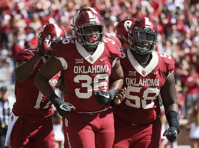 Oklahoma fullback Dimitri Flowers (36) celebrates a touchdown with teammate Erick Wren (58) on Oct. 7 against Iowa State in Norman, Okla. No. 2 Oklahoma and No. 3 Georgia meet for the first time today at the Rose Bowl in a College Football Playoff semifinal. 