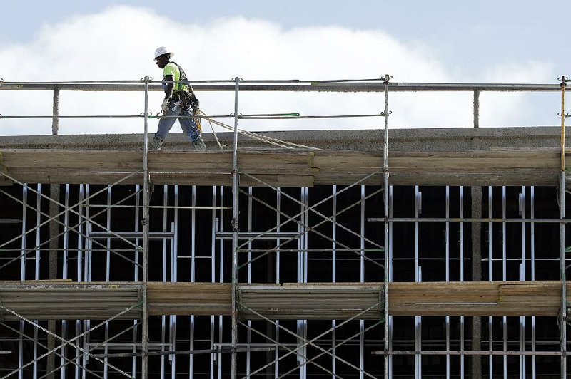 Workers build an apartment and retail complex in Nashville, Tenn., in October. The Commerce Department said Wednesday that private construction spending was up 1 percent in November.