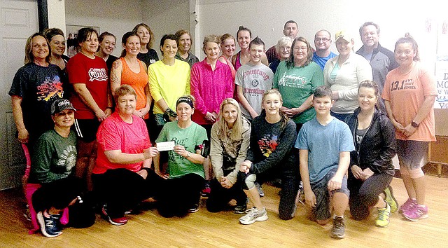 File photo/Sally Carroll/McDonald County Press Some of the proceeds of the Crawl/Walk/Run Fitness Class go to help fund special causes in the county. Earlier this year, members gathered before a fitness class to launch a new scholarship at McDonald County High School with a $350 donation that will benefit students needing food, funds for club attire and monetary help for additional ACT test registrations. Fitness classes kick off in mid-January.