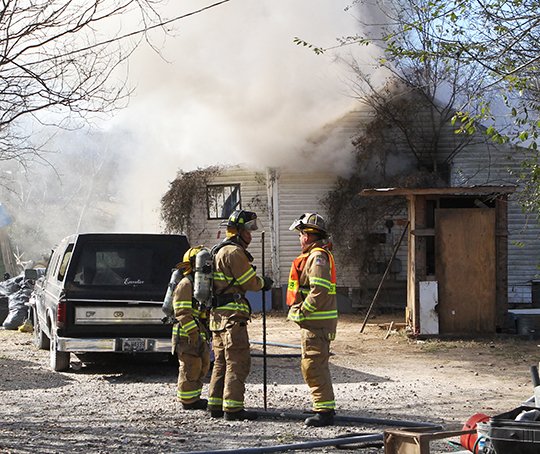 Hot Springs Fire Department firefighter work the scene of a house fire in the 1800 block of Spring Street Wednesday, January 3, 2017. The fire started around 12:30 p.m. (The Sentinel-Record/Richard Rasmussen)