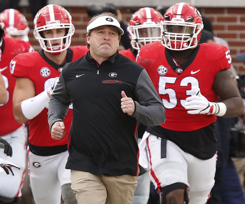 FILE - In this Nov. 25, 2017, file photo, Georgia head coach Kirby Smart leads his team onto the field before the start of a NCAA college football game against Georgia Tech, in Atlanta. Alabama and Georgia don't play as often as many would think so when the teams meet it's special, even when it is a regular season matchup. But when the Crimson Tide and Bulldogs meet Monday night, Jan. 8, 2018, in Atlanta it will be an event. The teams, which routinely play each other just four times a decade, will be playing for the College Football Playoff national championship. (Joshua L. Jones/Athens Banner-Herald via AP, File)
