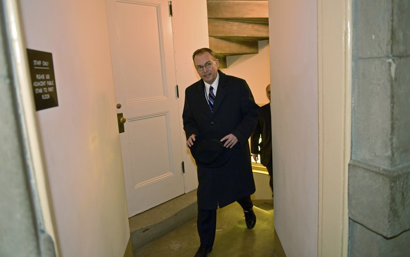 White House Budget Director Mick Mulvaney walks up a flight of stairs as he arrives for a meeting with House Speaker Paul Ryan of Wis., on Capitol Hill in Washington, Wednesday, Jan. 3, 2018. Ryan is hosting a meeting with Mulvaney, Legislative Director Marc Short and Republican and Democratic leaders of Congress. (AP Photo/Susan Walsh)