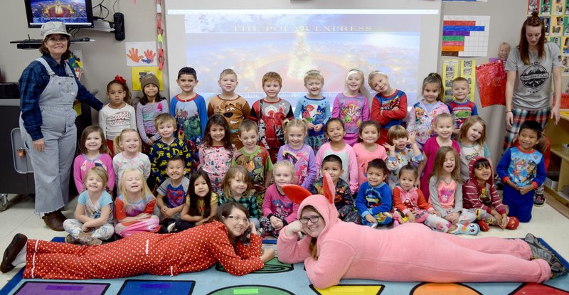 Engineer Joyce Turnage (upper left) takes a minute to have her passengers pose for the camera before they board the “Polar Express” Dec. 20. The combined pre-kindergarten classes of Turnage and Rachel Duncan at Decatur Pre-K watched the popular movie before the Christmas break.