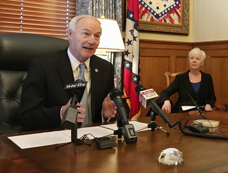 Arkansas Gov. Asa Hutchinson speaks to reporters at the state Capitol in Little Rock, Ark., on Thursday, Jan. 4, 2018, about a drop in the number of people enrolled in the state's Medicaid program. Hutchinson announced that the number of people on the traditional and expanded Medicaid programs dropped by more than 117,000 people from 2017 to 2018. (AP Photo/Andrew DeMillo)