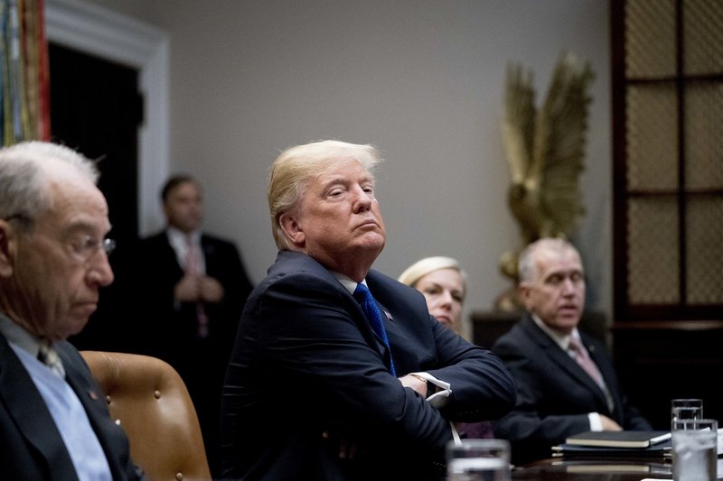 President Donald Trump, center, accompanied by Sen. Chuck Grassley, R-Iowa, left, Secretary of Homeland Security Kirstjen Nielsen, second from right, and Sen. Thom Tillis, R-N.C., right, listens during a meeting with Republican Senators on immigration in the Roosevelt Room at the White House, Thursday, Jan. 4, 2018, in Washington. (AP Photo/Andrew Harnik)