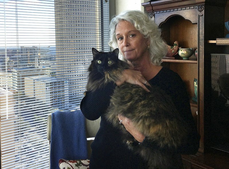 Christine Lee holds her long-haired house cat, Calli, in her condominium in downtown Tampa, Fla., on Thursday, Jan. 4, 2017. 