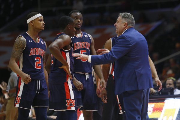 Auburn head coach Bruce Pearl talks with Auburn guard Bryce Brown (2), Auburn guard Jared Harper, center, and Auburn guard Mustapha Heron (5) during a time out in the second half of an NCAA college basketball game Tuesday, Jan. 2, 2018, in Knoxville, Tenn. (AP Photo/Crystal LoGiudice)

