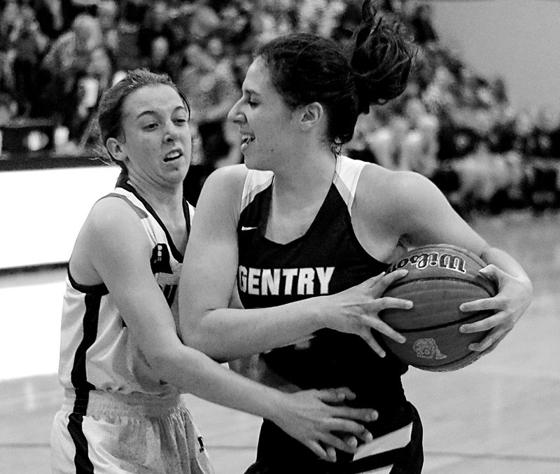 Hannah Boss, a Gentry senior, grabs a rebound and shields it from Gabbi Curtis, a Gravette sophomore, during play in Gravette on Friday, Jan. 5, 2018.