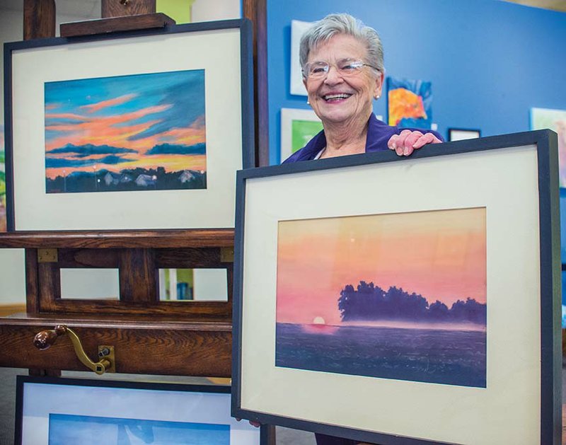 Maumelle artist Mary Ann Stafford will be the featured artist at Art on the Green in Conway through Feb. 7. She is shown here with two of her newest pastel paintings, In the Neighborhood, left, and Sarah’s Bean Fields. The public is invited to meet Stafford and view her work at the opening reception, set for 3:30-5:30 p.m. Thursday.