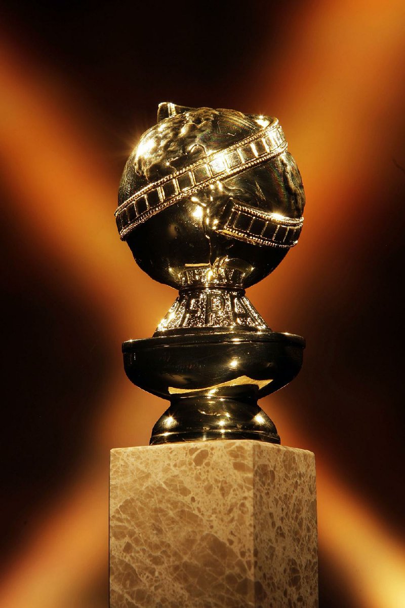The Golden Globe trophy is 10.75 inches tall and weighs 5.5 pounds. The top is a 24-karat gold-plated zinc die-cast globe wrapped by a filmstrip. The globe’s base contains the HFPA letters atop a golden cup. All that sits on a base of marble with a tapered sub base atop a rectangular pillar.