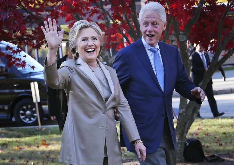 FILE - In this Nov. 8, 2016, file photo, then-Democratic presidential candidate Hillary Clinton, and her husband former President Bill Clinton, greet supporters after voting in Chappaqua, N.Y. The FBI is investigating allegations of corruption connected to the Clinton Foundation while Hillary Clinton was secretary of state. That‚Äôs according to a person familiar with the investigation who spoke on condition of anonymity to discuss it.  (AP Photo/Seth Wenig, File)