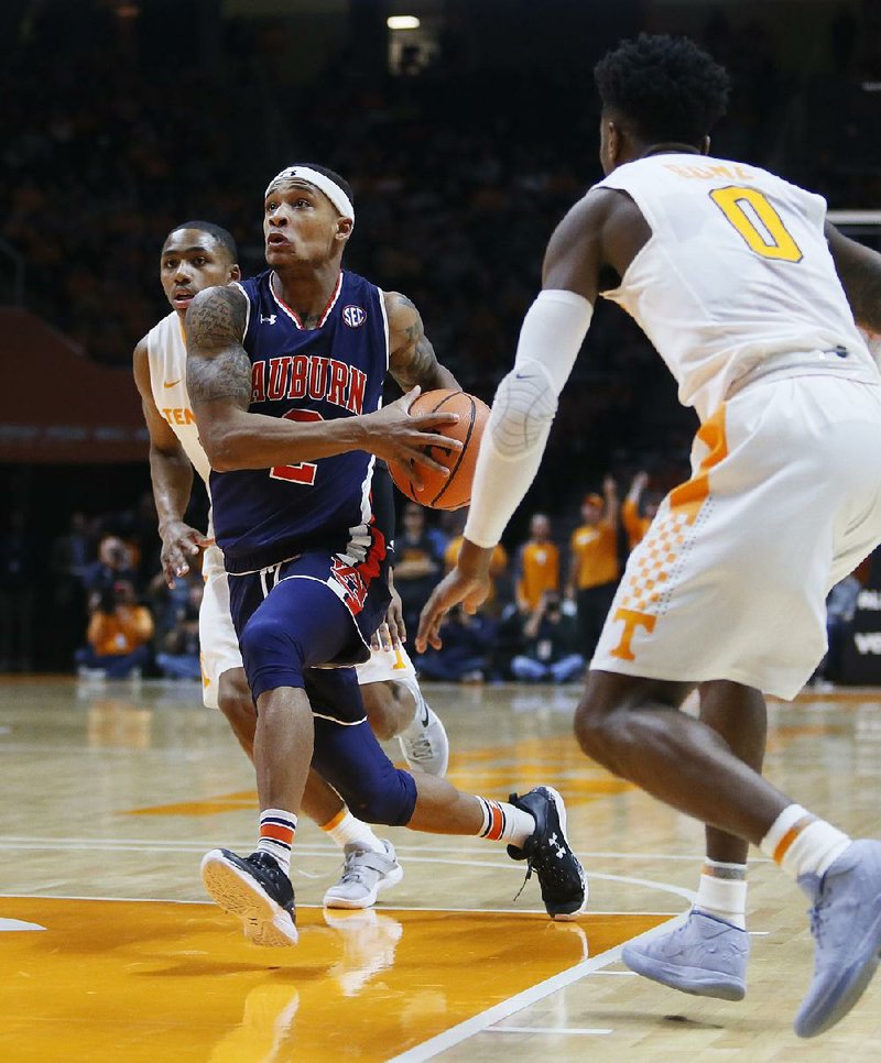 Auburn guard Bryce Brown (2) drives the ball toward the basket beside Tennessee guard Jordan Bone (0) in the second half of an NCAA college basketball game Tuesday, Jan. 2, 2018, in Knoxville, Tenn. (AP Photo/Crystal LoGiudice)