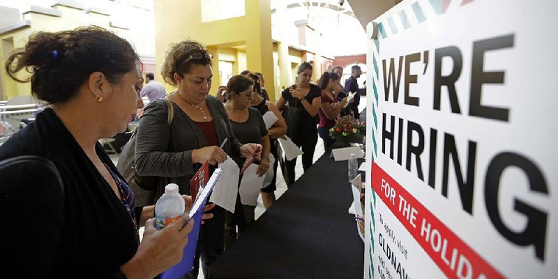 People wait to apply for seasonal employment at a job fair in Sweetwater, Fla., in October. Payroll processor ADP reported December job gains reflected hiring in health care, professional services and retail. 