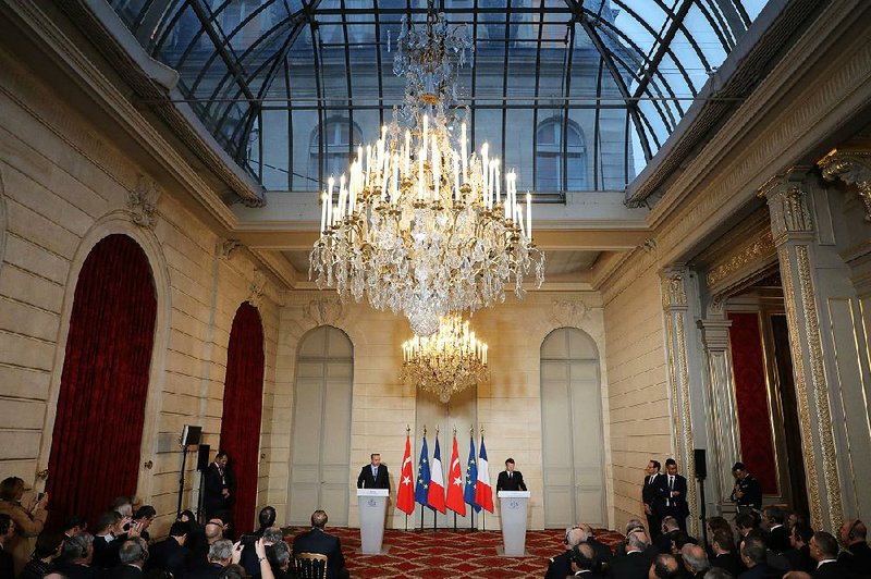 Turkish President Recep Tayyip Erdogan and French President Emmanuel Macron hold a news conference Friday at the Elysee Palace in Paris after talks on Turkey and the European Union. 