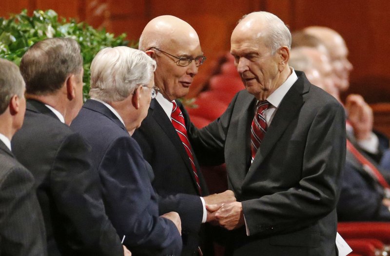 FILE - In this Sept. 30, 2017, file photo, Russell M. Nelson, right, president of the Quorum of the Twelve Apostles, right, greets members of the Quorum, before the start of the morning session of the two-day Mormon church conference, in Salt Lake City. President Thomas S. Monson, of The Church of Jesus Christ of Latter-day Saints, the 16th president of the Mormon church, died Tuesday, Jan. 2, 2018, after nine years in office. He was 90. The next president was not immediately named, but the job is expected to go to next longest-tenured member of the church's governing Quorum of the Twelve Apostles, Nelson, per church protocol. (AP Photo/Rick Bowmer, File)