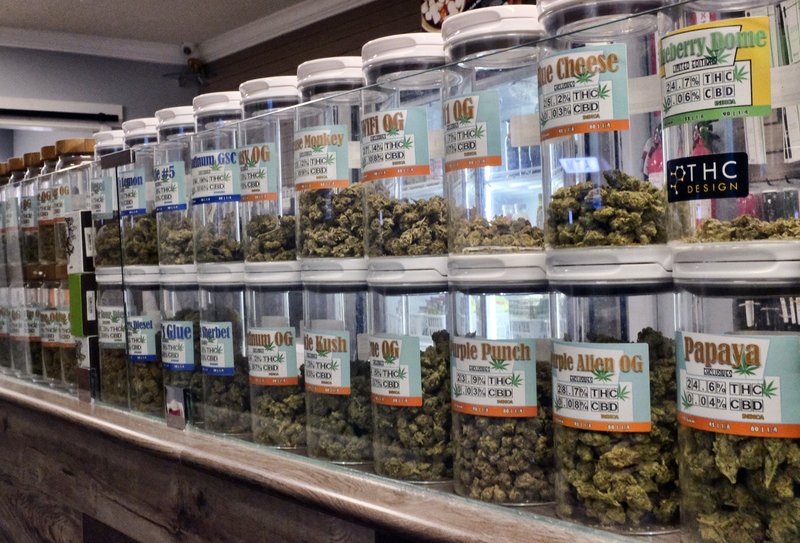 FILE - This Friday, Nov. 3, 2017 photo shows jars of medical marijuana on display on the counter of Western Caregivers Medical marijuana dispensary in Los Angeles. When U.S. Attorney General Jeff Sessions green-lighted federal prosecutors to pursue violators of federal marijuana laws, not only states that legalized recreational pot are at risk of a crackdown, but so is most of the rest of America. All but four states allow some form of medical marijuana, even Sessions' home state of Alabama. (AP Photo/Richard Vogel, File)