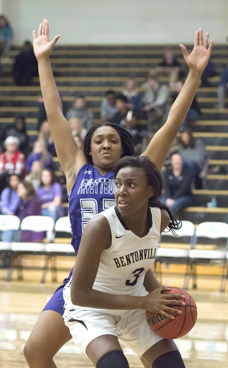 Bentonville High forward Fess Hawkins (3) looks to pass Friday as Fayetteville’s Jasmine Franklin defends at Bentonville High School in Bentonville.