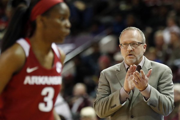 Arkansas coach Mike Neighbors applauds his players as a timeout is called in the first half of an NCAA college basketball game against Mississippi State in Starkville, Miss., Thursday, Jan. 4, 2018. Mississippi State won 111-69. (AP Photo/Rogelio V. Solis)

