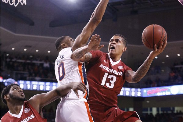 Arkansas forward Dustin Thomas drives the ball to the basket against Auburn forward Horace Spencer during the first half of an NCAA college basketball game Saturday, Jan. 6, 2018, in Auburn, Ala. (AP Photo/Brynn Anderson)

